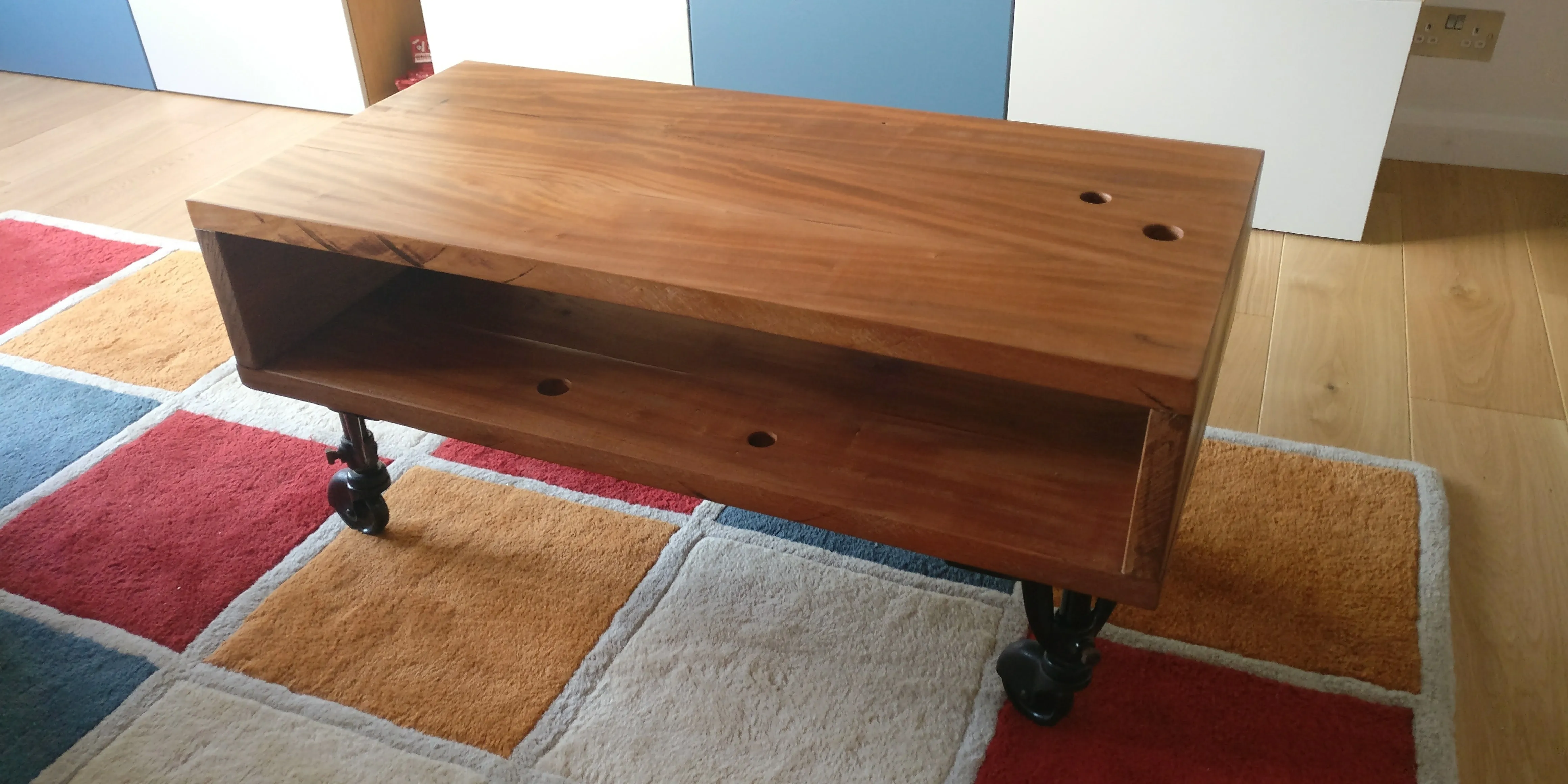 a coffee table I made with old industrial roller wheels and wood